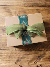 Load image into Gallery viewer, Vintage Christmas candle hamper box with candle, mini diffuser, wax melt, and festive decorations in straw, wrapped with hessian ribbon and metallic sash