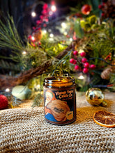 Load image into Gallery viewer, Spiced Orange Candle in an amber glass jar, with a vintage orange illustration and a black-and-gold label.