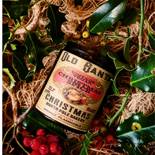 Load image into Gallery viewer, Christmas Spice Vintage Vegan Candle in a black glass jar with a cream and red vintage Santa label and bold lettering.