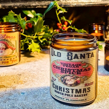 Load image into Gallery viewer, Christmas Spice Vintage Vegan Candle in an amber glass jar, with a cream and pink vintage Santa label and black lettering.