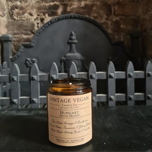 Load image into Gallery viewer, Hungary Spiced Orange soy wax candle 180ml with orange, cinnamon, and vanilla scent notes in personalized vintage packaging