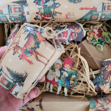 Load image into Gallery viewer, Nostalgic Christmas candle hamper box with gift wrapped candle, mini diffuser, wax melt, and festive decorations in straw with hessian ribbon and metallic sash