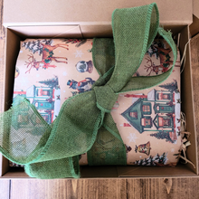 Load image into Gallery viewer, Christmas candle hamper box wrapped in vintage festive paper with green hessian ribbon and straw filling inside a gift box