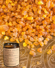 Load image into Gallery viewer, Nepalese frankincense and vanilla soy wax candle with vintage vegan label and resin background