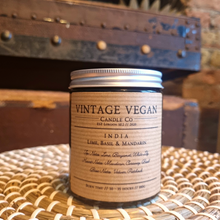 Load image into Gallery viewer, India Lime Basil & Mandarin soy wax candle 180ml with vintage vegan label on wicker surface