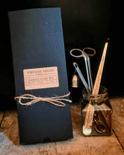 Load image into Gallery viewer, Luxury candle care kit with stainless steel wick trimmer, candle snuffer, and wick dipper in black packaging and glass jar