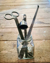 Load image into Gallery viewer, Luxury Candle Care Kit with stainless steel wick trimmer, candle snuffer, and wick dipper in glass jar on wooden surface