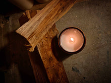 Load image into Gallery viewer, Burning Moroccan Midnight Opium soy wax candle 180ml next to wood pieces on concrete surface