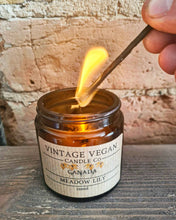 Load image into Gallery viewer, Hand lighting black candle match over Vintage Vegan Candle Co jar with Meadow Lily scent