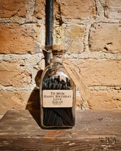 Load image into Gallery viewer, Personalised jar of candle matches with black sticks and custom kraft label in a corked glass bottle