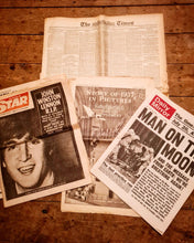 Load image into Gallery viewer, Vintage newspapers including John Lennon R.I.P. and Man on the Moon headlines on wooden surface