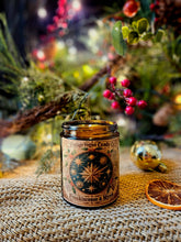 Load image into Gallery viewer, Frankincense and Myrrh Luxury vegan candle in a clear glass jar with a vintage celestial label and black lid.
